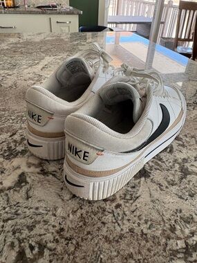 Nike White Sneakers with Black Swoosh and Tan Accent